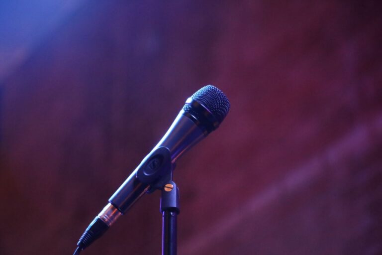 best-selling product-01 A microphone on a stand against a blurred background, perfect for music or event themes.